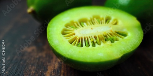 Melon Bitter Close up of a halved bitter melon with vibrant green flesh and seeds, dewdrops on its rough skin. Extreme close up macro shot of a halved bitter melon, revealing its vibrant green,