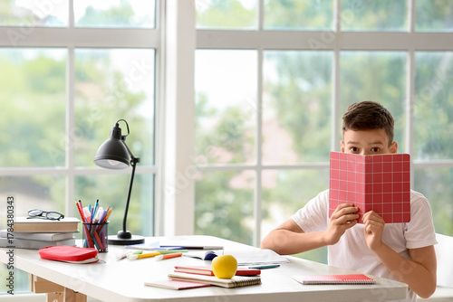 Little boy with copybook do...