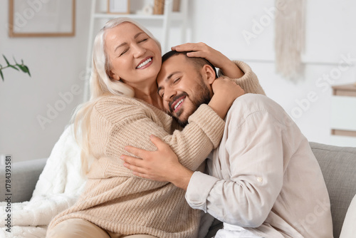 Mature woman hugging her so...