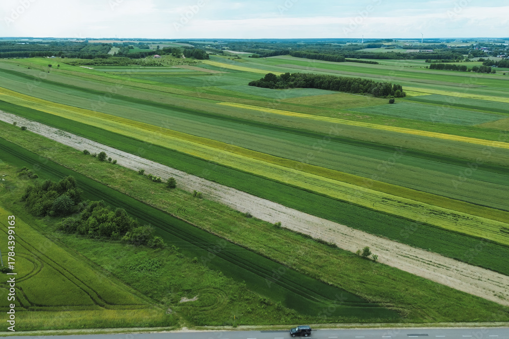 Obraz premium Drone view of peaceful rural farmland and crop field