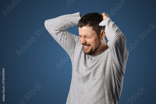 Screaming young man on dark...