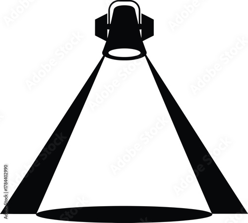 Spotlight illuminating a stage in a dark room.