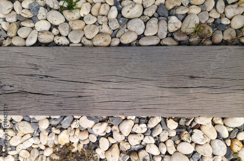 Rough wooden planks are laid horizontally on the walkway