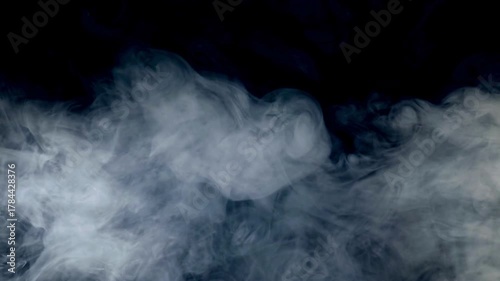 Light Blue smoke and fog abstract background Loopable abstract swirling smoke and a soft, radiant light rising from below against a black background  useful as an overlay layer, dynamic and ethereal