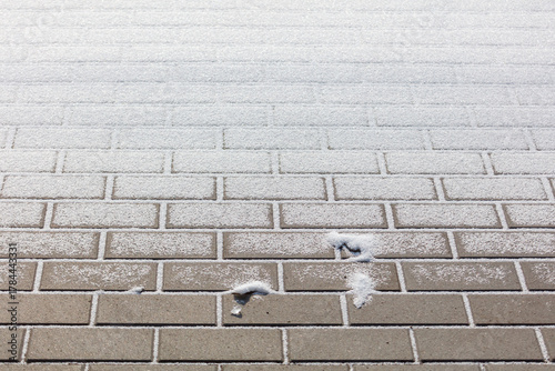 A brick wall covered in snow