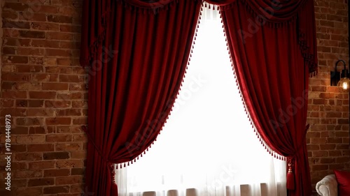 Elegant Red Curtains Drape a Bright Window Against a Textured Brick Wall Interior with Natural Light Casting a Warm Glow Featuring a Luxurious and