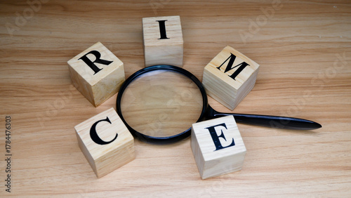 Photos Crime investigation concept with magnifying glass and wooden blocks