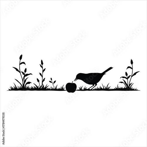 Silhouette of a small bird pecking a fresh red apple in green grass plants