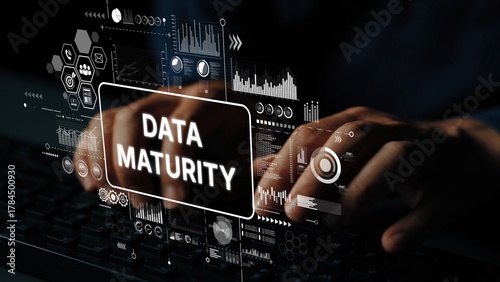 Hands Typing on Keyboard with Data Maturity Concept and Digital Analytics Graphics in Background. Asymptotic smart data analytic.