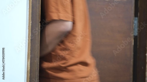 Close-up of a person using a key card to unlock a door with a modern electronic handle, commonly seen in hotels or offices.
