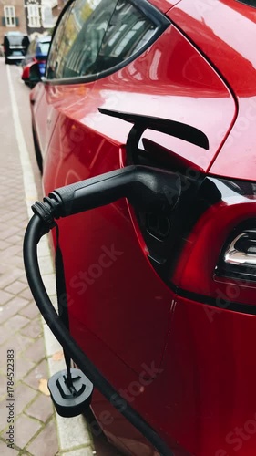 Charging an electric car in the streets of Amsterdam during a sunny afternoon