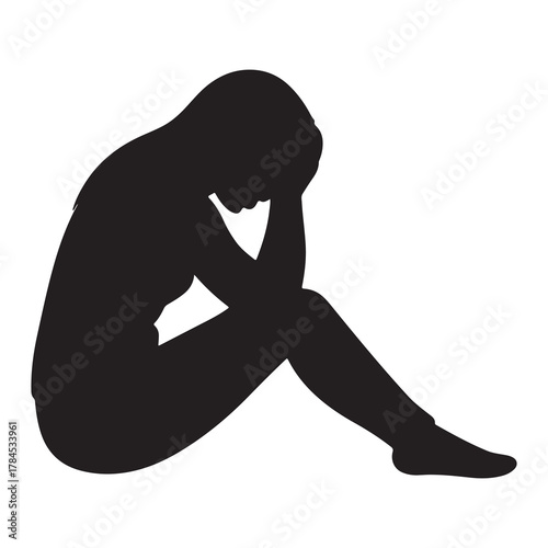 Silhouette of a person sitting alone with head in hands expressing sadness and despair