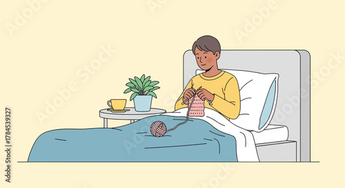 A Person Knitting Comfortably in Bed, Relaxing and Enjoying a Cozy Indoor Activity