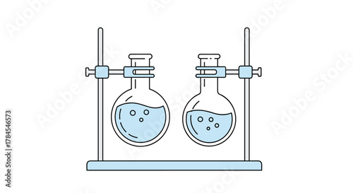 Two round bottom flasks containing liquid and bubbles stand on a laboratory support.