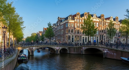 Scenic Canal View in Amsterdam with Historic Buildings and Bridges at Sunset.