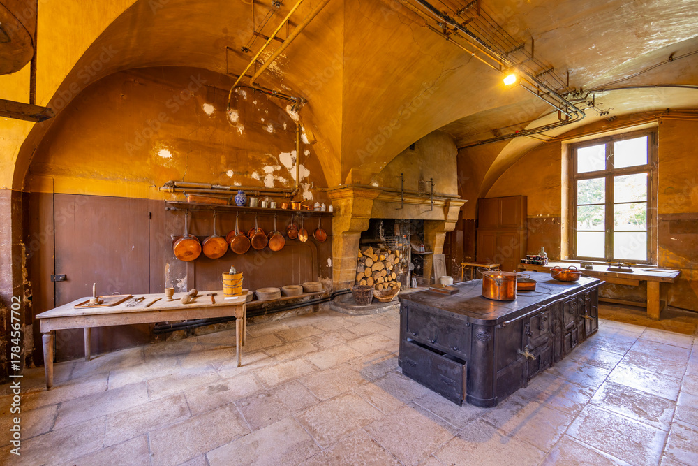 Naklejka premium Traditional Chateau de Commarin kitchen with historical iron stove