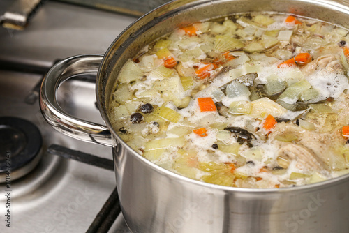 Photography Large pot with homemade soup boiling on stove