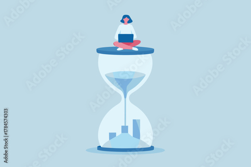 Woman working on laptop on top of hourglass with financial graph at the bottom representing time and money concept