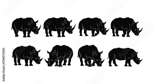 A group of rhinoceros silhouettes standing together