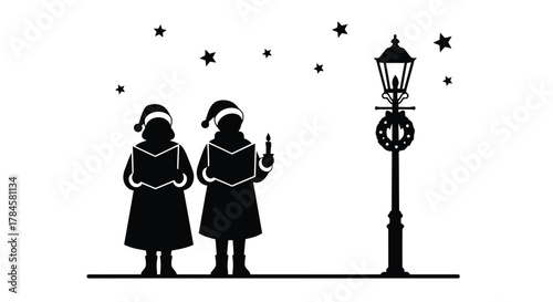 Children singing carols by lamppost at night