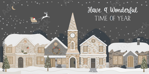 Charming snow covered village scene with santa and reindeer flying overhead during winter holidays