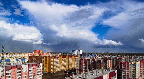 Amazing cloudy landscape above multi-colored residential buildings