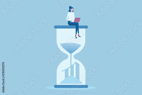 Woman working on laptop on top of hourglass with falling sand and business graph inside