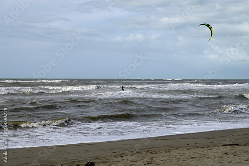 Kitesurfing at italian beach. Some kitesurfers at Torre del Lago beach, tuscany, italy. Some are junping out of the water. Mediterraenean Sea.