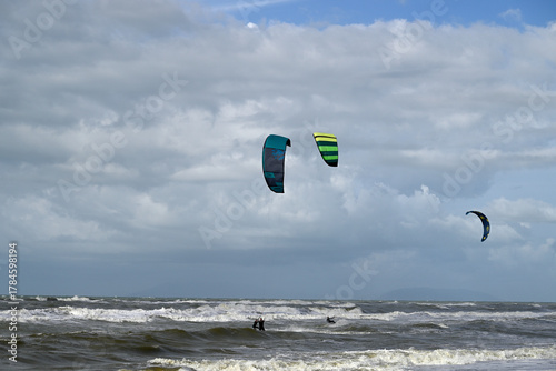 Kitesurfing at italian beach. Some kitesurfers at Torre del Lago beach, tuscany, italy. Some are junping out of the water. Mediterraenean Sea.