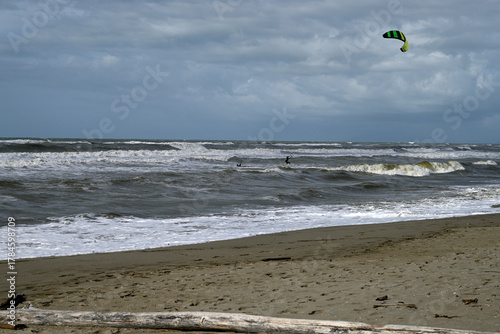 Kitesurfing at italian beach. Some kitesurfers at Torre del Lago beach, tuscany, italy. Some are junping out of the water. Mediterraenean Sea.