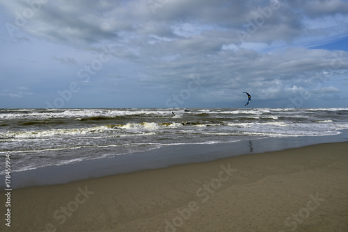 Kitesurfing at italian beach. Some kitesurfers at Torre del Lago beach, tuscany, italy. Some are junping out of the water. Mediterraenean Sea.