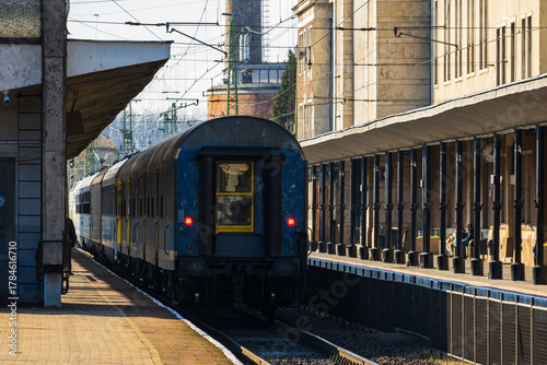 Passenger train departing from urban railway station
