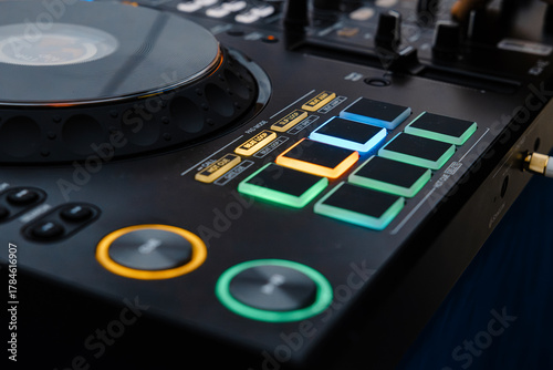 Close-up of colorful DJ controller with illuminated pads
