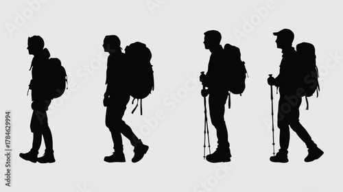 Silhouettes of hikers with backpacks and trekking poles walking.