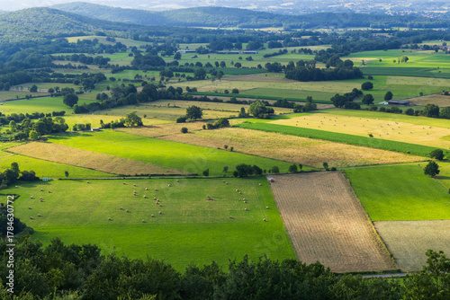 French agricultural landscape with green fields and hay bales