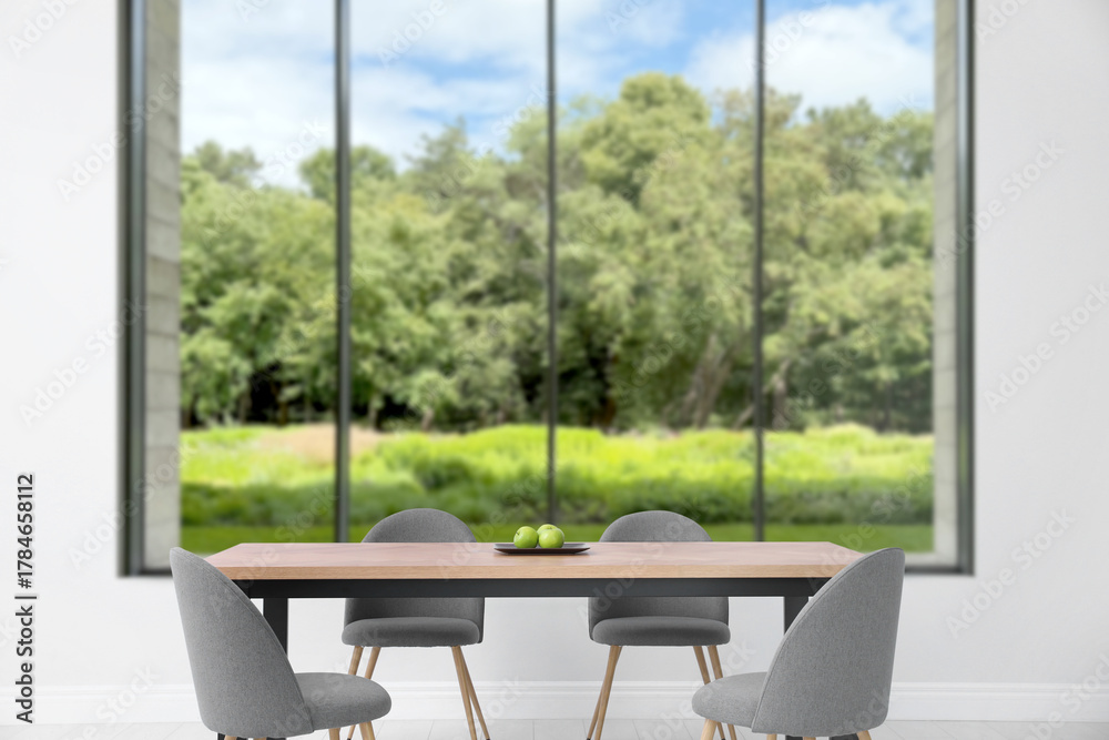Fototapeta premium Table and chairs near window in room. Interior design