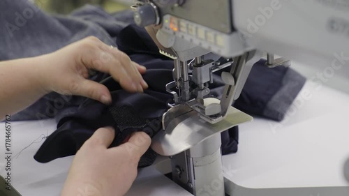 Industrial Sewing Machine in Action. Close-up Textile Factory Footage
