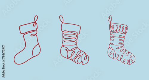 Set of three continuous line drawings of Christmas stockings or socks on a light blue background, symbolizing holiday gifts and celebration.