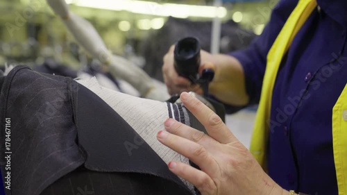 Industrial Ironing Process in Textile Factory. Close-up of Fabric Pressing