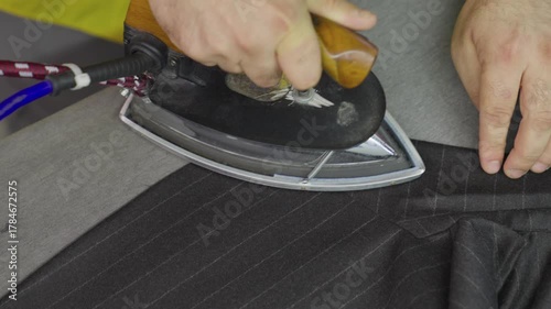 Industrial Ironing Process in Textile Factory. Close-up of Fabric Pressing