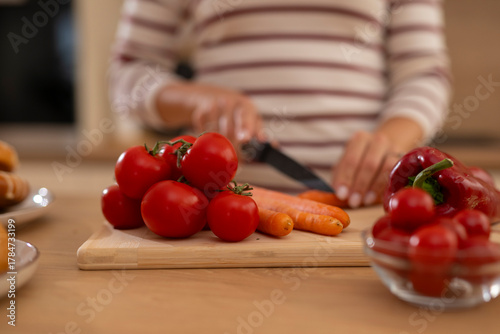 Woman preparing healthy vegetables for cooking in kitchen