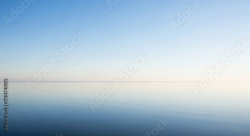 Fototapeta Naklejka Na Ścianę i Meble -  Calm blue ocean meets the clear sky on a sunny day at the horizon
