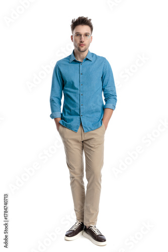 Casual man standing with hands in pockets