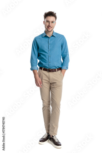 Happy casual man standing with hands in pockets