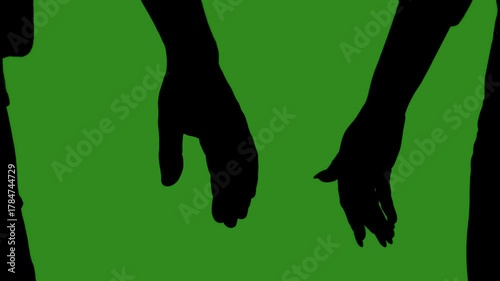 Black silhouettes of a couple holding hands in close up against a green chroma key background. Minimalist contrast and modern visual composition, mockup.