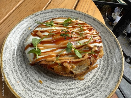 Hiroshima style okonomiyaki with fried  eggs for breakfast