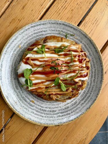 Hiroshima style okonomiyaki with fried  eggs for breakfast