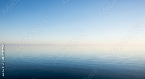 Fototapeta Naklejka Na Ścianę i Meble -  Calm sea and clear sky create a serene and peaceful atmosphere