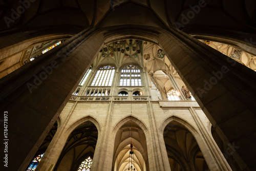 Kutná Hora, Czech Republic – August 8, 2025: Upward view of Gothic vaulted ceiling and stone columns with heraldic coats of arms inside St. Barbara’s Cathedral, Kutná Hora