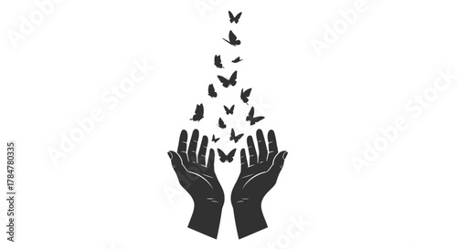 Silhouette of open hands releasing a flock of butterflies into the sky symbolizing freedom and new beginnings